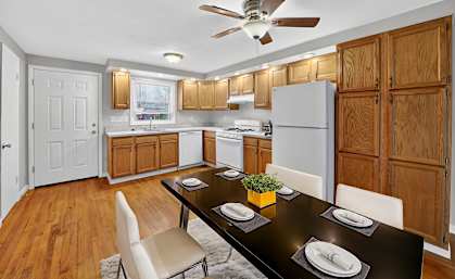 A kitchen with a table set for two.