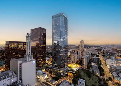 A cityscape with tall buildings and a clear sky.