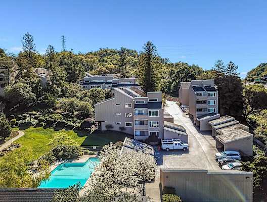 aerial view of apartment buildings and pool