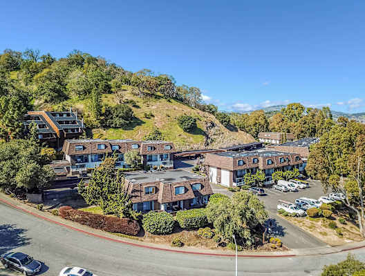 aerial view of apartment buildings and hillside