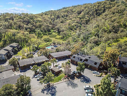 aerial view of apartment buildings and hillside