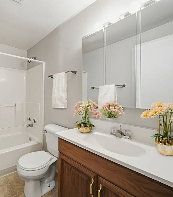 A white bathroom with a toilet, sink, and bathtub.