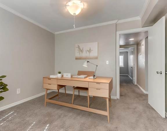 A room with a desk and a lamp.