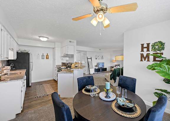 A dining room with a table set for four.