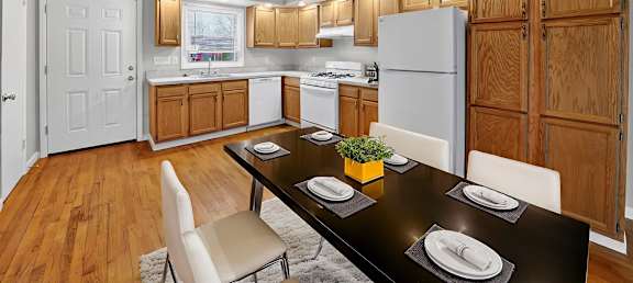 A kitchen with a table set for two.