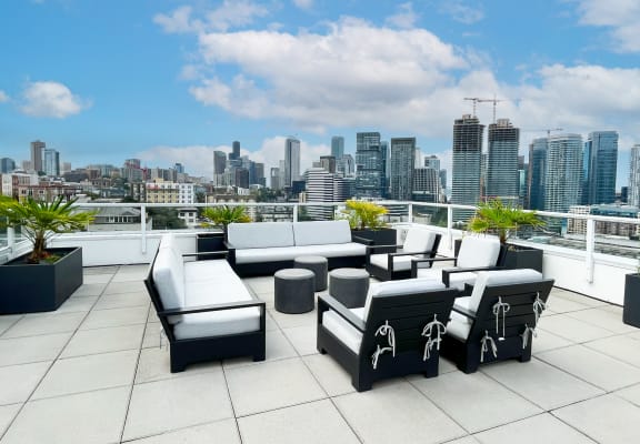 a terrace with couches and chairs overlooking a city  at Oslo, Seattle, Washington