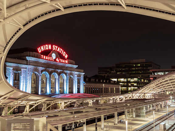 A train station with a sign that says Union Station Travel 4 Train.