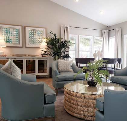 a living room with blue chairs and a table at Madison Oaks Apartment Homes, LLC, Palm Harbor, FL 34684