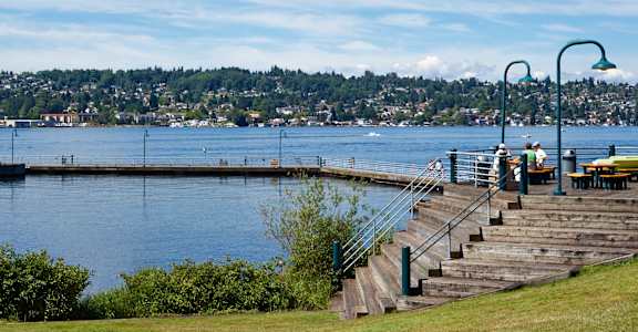 a dock on a lake with people sitting on it at 2000 Lake Washington Apartments, Renton, WA, 98056