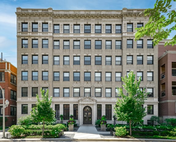 the facade of a building with trees in front of it