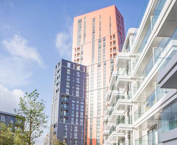 a group of tall buildings in front of a blue sky