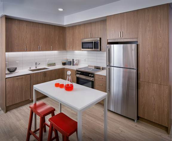 A modern kitchen with a table and chairs.