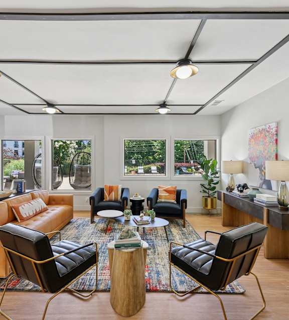A modern living room with a large window and a view of trees outside.