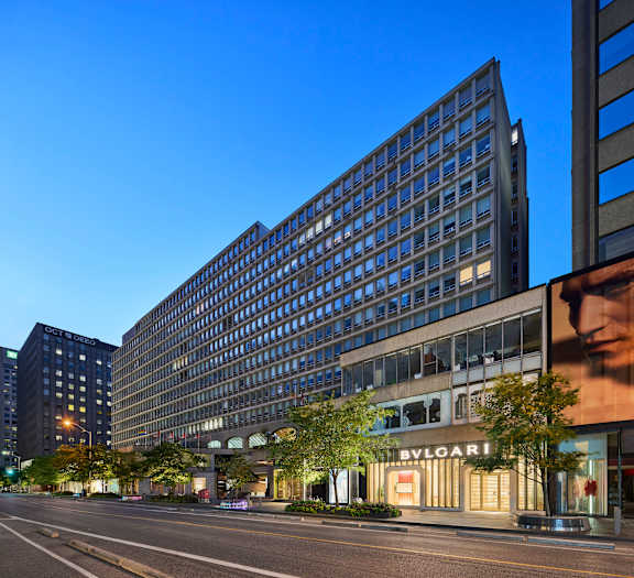 a large building on a city street with cars