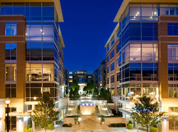 A modern building with glass windows and a courtyard in the center.