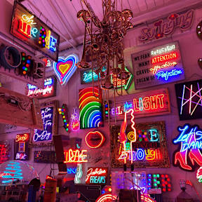 Colourful neon signs and light installations inside God's Own Junkyard gallery.