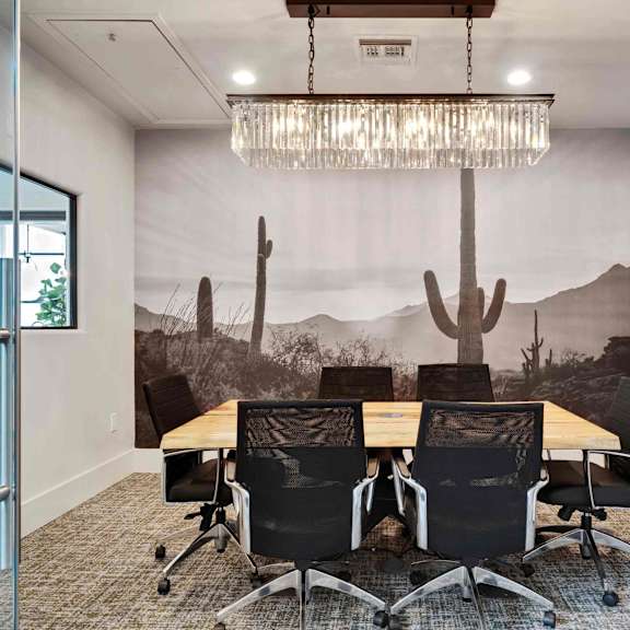 A conference room with a desert mural on the wall.
