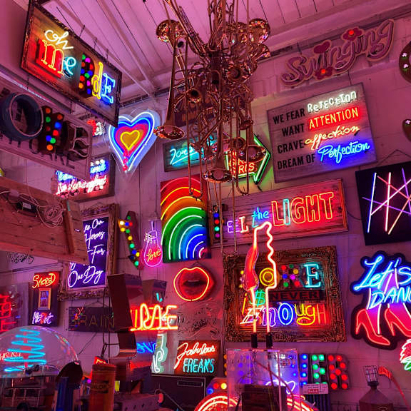 Colourful neon signs and light installations in God's Own Junkyard gallery.