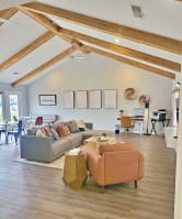 a living room with couches and chairs and a dining room table