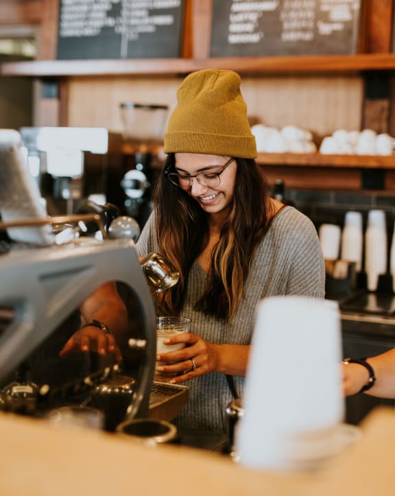 a barista making coffee at The Ridge at Thornton Station in Thornton, CO