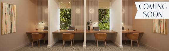 A room with four desks and two chairs.