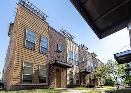 Building with a sidewalk in front of it at 7th Street Brownstones, Indigo Living, IA