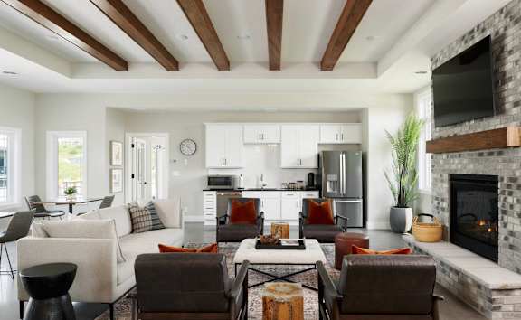A modern living room with a fireplace and a dining area.