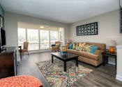 Thumbnail 7 of 24 - Wood-style flooring runs throughout the living areas in each apartment home.