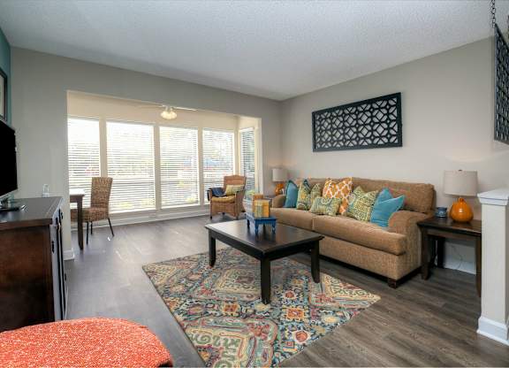 Wood-style flooring runs throughout the living areas in each apartment home.
