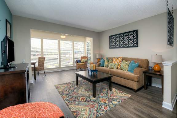 Wood-style flooring runs throughout the living areas in each apartment home.