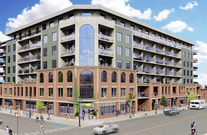 Modern multi-story residential building sits on a busy street with cars and pedestrians.