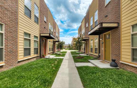 Building with Beautiful Walking Paths at 7th Street Brownstones, Indigo Living, IA, Iowa