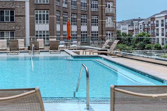 our apartments have a pool and a large building with umbrellas