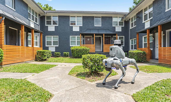 A statue of a horse is in the middle of a courtyard.