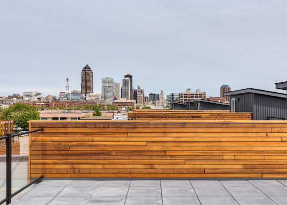 a wooden wall on a roof with a city skyline in the background at 5Fifty5, Des Moines, IA 50309