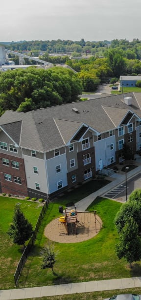 an aerial view of an apartment building in a parking lot