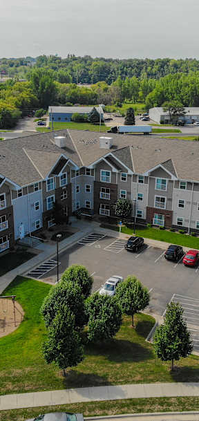 an aerial view of an apartment building in a parking lot