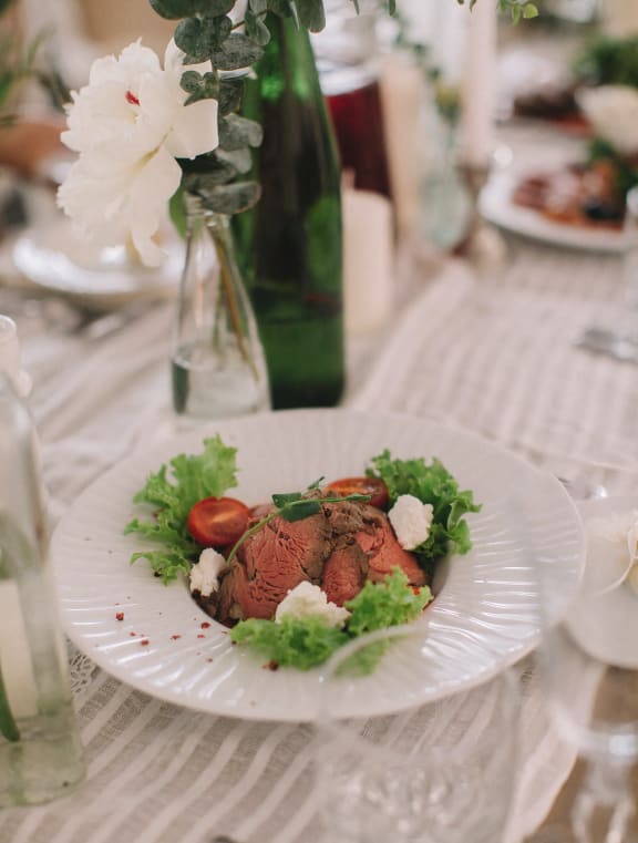 a plate of food on a table at a wedding