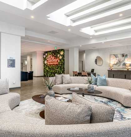 A modern living room with a grey sofa and a coffee table.