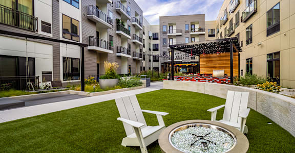 A modern courtyard with a fire pit and seating area.at Center Square Lofts East, Pennsylvania, 18101