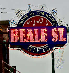 A neon sign for Beale Street Gifts with a musical theme.