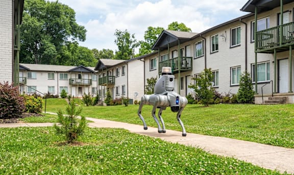 A horse statue is in the front yard of a residential building.