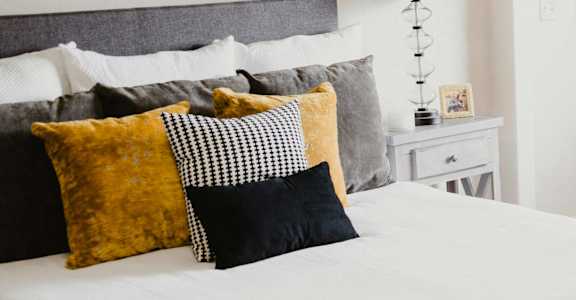 a bedroom with a bed and a couch and a window