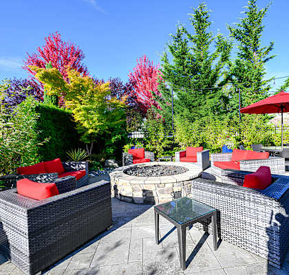 A patio with a fire pit and seating area.