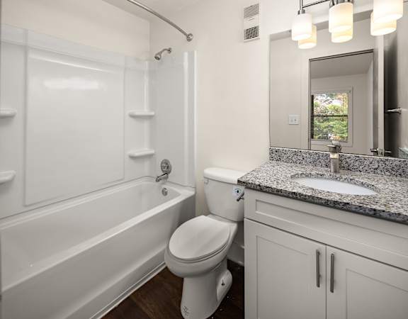 a bathroom with a sink toilet and a bath tub
