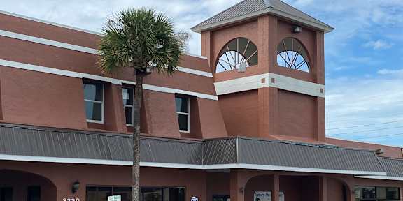 a building with a clock tower on top of it at Colonial Apartments, Orlando, 32808
