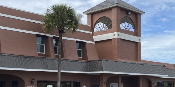 a building with a clock tower on top of it at Colonial Drive Apartments, Orlando, 32808