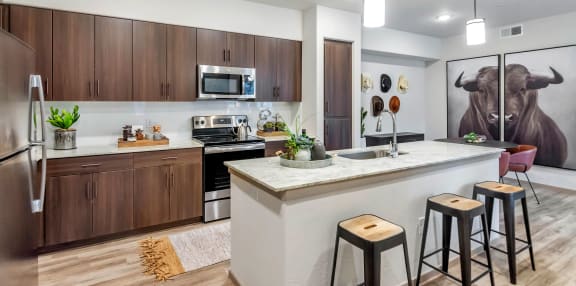 a kitchen with a bar and stools in front of a counter topat Homestead Talking Glass, Prescott Valley