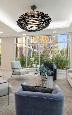 A modern living room with a large window and a view of the outdoors.