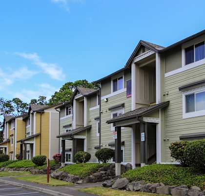 A row of townhouses with green and yellow siding.